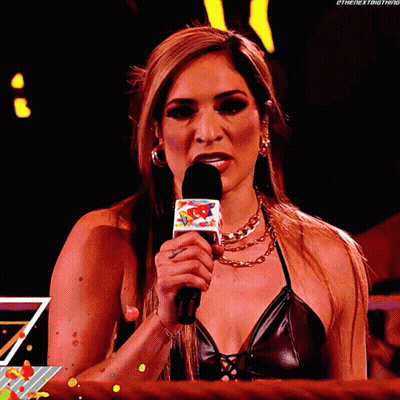 A Woman In A Black Top Is Holding A Microphone That Says ' Ethenextbigthing ' On It GIF