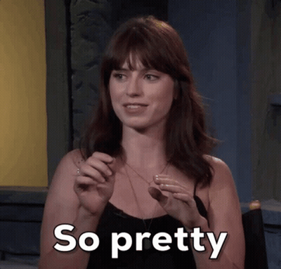 A Woman In A Black Top Says So Pretty In White Letters GIF