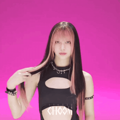 A Woman In A Black Top With Choom Written On It GIF