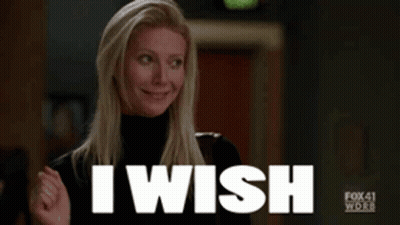 A Woman In A Black Turtleneck Is Smiling And Saying I Wish GIF