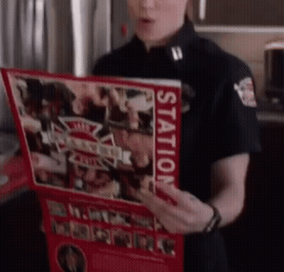 A Woman In A Black Uniform Is Holding A Red Book That Says Station On It GIF