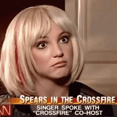 A Woman In A Blonde Wig Is Talking On A News Channel . GIF