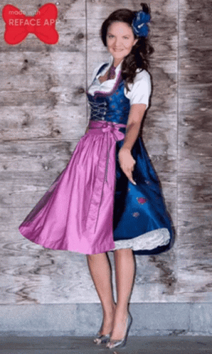 A Woman In A Blue And Purple Dress With A Flower In Her Hair GIF