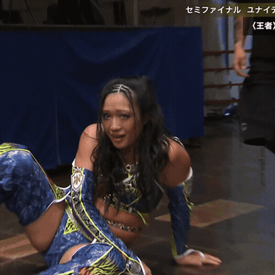 A Woman In A Blue And Purple Outfit Is Crying With Chinese Writing Behind Her GIF