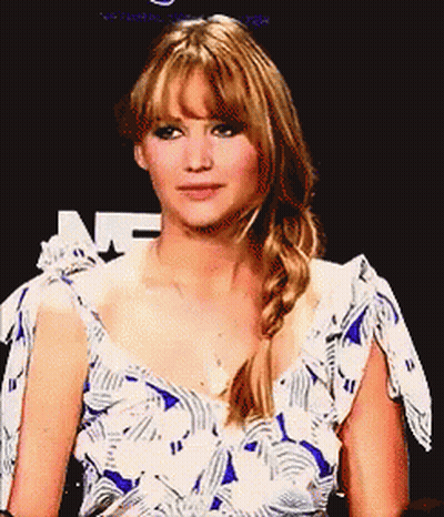 A Woman In A Blue And White Dress With A Braid On Her Hair GIF