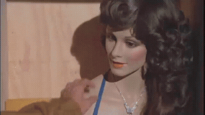 A Woman In A Blue Bikini Is Standing Next To A Mannequin . GIF