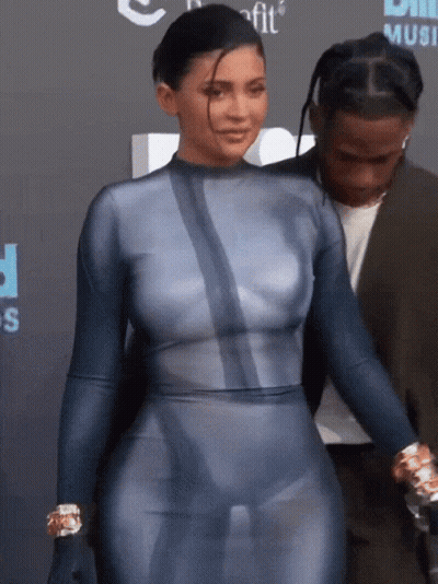 A Woman In A Blue Bodysuit Is Standing Next To A Man GIF