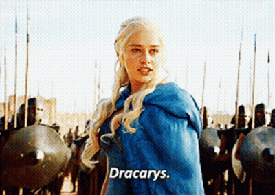 A Woman In A Blue Cape Is Standing In Front Of A Row Of Soldiers And Says " Dracarys " GIF