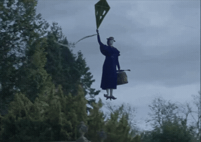 A Woman In A Blue Coat And Red Hat Is Flying Through The Air Holding A Ribbon GIF