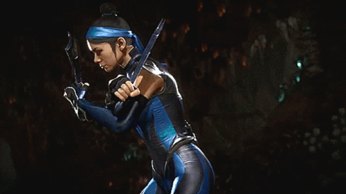 A Woman In A Blue Costume Is Holding A Sword In Her Hands GIF
