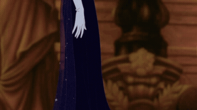 A Woman In A Blue Dress And White Gloves Stands In A Dark Room GIF