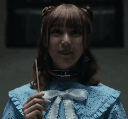 A Woman In A Blue Dress Holding A Stick GIF