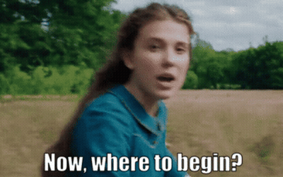 A Woman In A Blue Dress Is Asking Where To Begin GIF