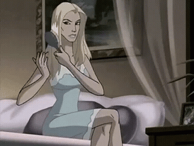 A Woman In A Blue Dress Is Brushing Her Hair While Sitting On A Bed . GIF