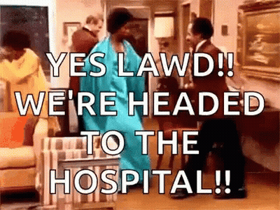 A Woman In A Blue Dress Is Dancing In A Living Room While A Man In A Suit Stands Behind Her . GIF