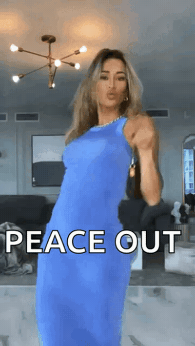 A Woman In A Blue Dress Is Dancing In A Living Room With The Words Peace Out Written On The Screen . GIF