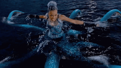 A Woman In A Blue Dress Is In The Water With The Words True Love 'S Kiss Won 'T Defeat This GIF