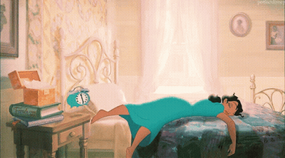A Woman In A Blue Dress Is Laying On A Bed Next To An Alarm Clock And A Book Titled " French Kiss " GIF