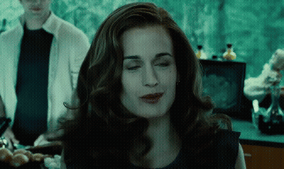 A Woman In A Blue Dress Is Making A Funny Face With Her Eyes Closed GIF