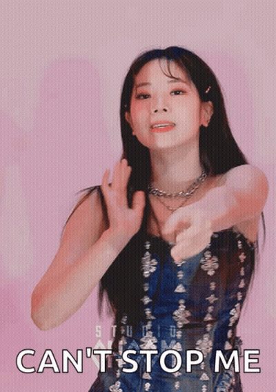 A Woman In A Blue Dress Is Pointing At The Camera With The Words " Can 'T Stop Me " Written Below Her GIF