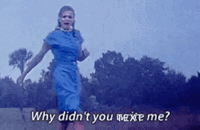 A Woman In A Blue Dress Is Running In A Field With The Words `` Why Didn 'T You Text Me '' . GIF