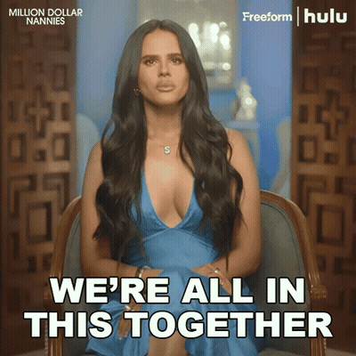 A Woman In A Blue Dress Is Sitting In A Chair With The Words We 'Re All In This Together GIF