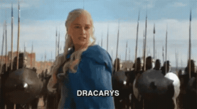 A Woman In A Blue Dress Is Standing In Front Of A Crowd Of Soldiers And The Word Dracarys Is Written On The Bottom GIF