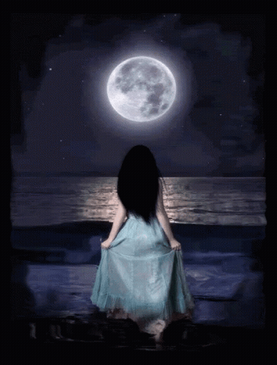 A Woman In A Blue Dress Is Standing In Front Of A Full Moon Over The Ocean GIF