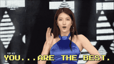 A Woman In A Blue Dress Is Standing In Front Of A Screen That Says You Are The Best GIF