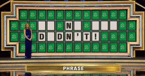 A Woman In A Blue Dress Is Standing In Front Of A Wheel Of Fortune Wheel That Says " Phrase " GIF
