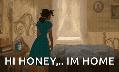 A Woman In A Blue Dress Is Standing Next To A Bed In A Bedroom And Looking Out The Window . GIF