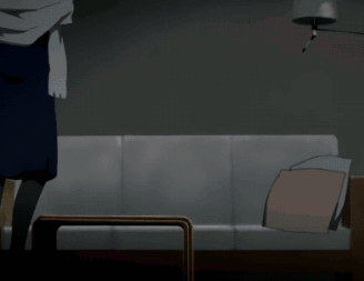 A Woman In A Blue Dress Is Standing Next To A Couch GIF