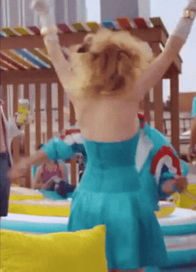 A Woman In A Blue Dress Is Standing With Her Arms Outstretched GIF