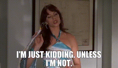A Woman In A Blue Dress Is Talking On A Cell Phone . GIF