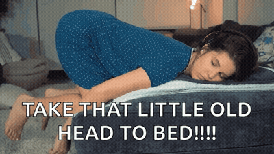 A Woman In A Blue Dress Laying On A Bed With The Words Take That Little Old Head To Bed GIF