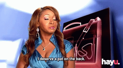 A Woman In A Blue Dress Says I Deserve A Pat On The Back GIF