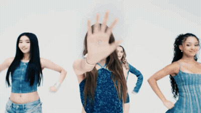 A Woman In A Blue Dress Stands In Front Of A Group Of Women GIF