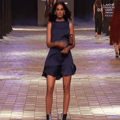 A Woman In A Blue Dress Walks Down The Runway At The Lakme Fashion Week GIF
