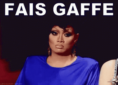 A Woman In A Blue Dress With The Words " Fais Gaffe " On Her Face GIF