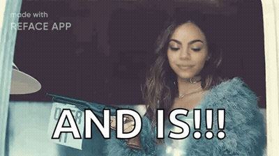A Woman In A Blue Fur Coat Is Holding A Gun And Is ! GIF