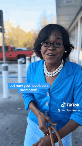 A Woman In A Blue Jacket And Pearls Says But Now You Have Been Promoted On A Tiktok GIF