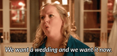 A Woman In A Blue Jacket Says We Want A Wedding And We Want It Now GIF
