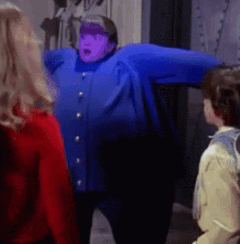 A Woman In A Blue Jacket With A Purple Face GIF