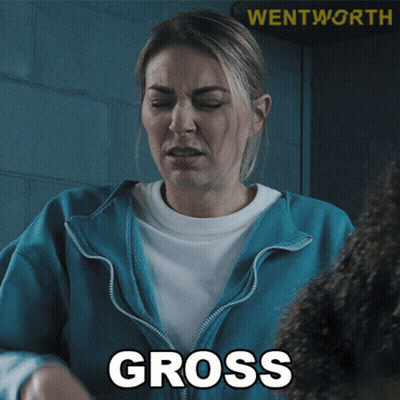 A Woman In A Blue Jacket With The Word Gross On Her Chest GIF