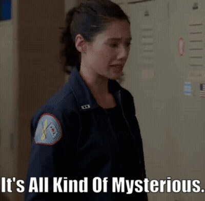 A Woman In A Blue Jacket With The Words It 'S All Kind Of Mysterious GIF