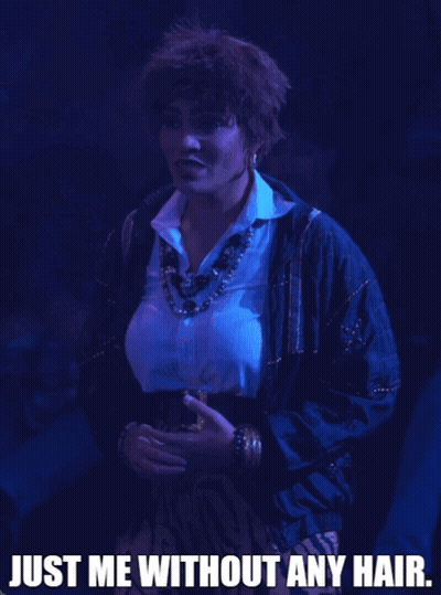 A Woman In A Blue Jacket With The Words Just Me Without Any Hair GIF