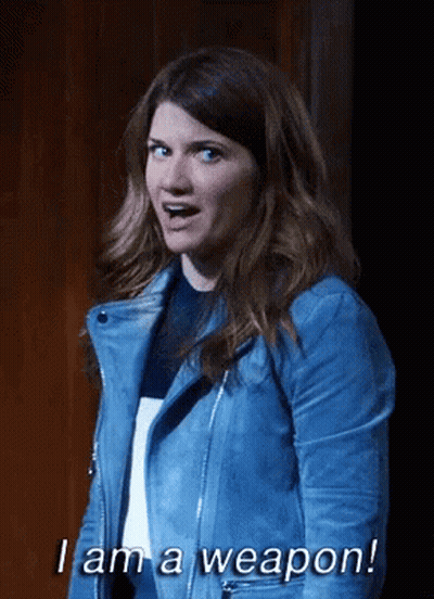 A Woman In A Blue Leather Jacket Says I Am A Weapon GIF