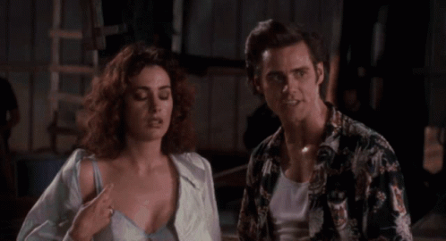 A Woman In A Blue Leotard Is Being Held By A Man In A Red Robe . GIF