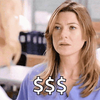A Woman In A Blue Scrub Top Has A Dollar Sign On Her Chest GIF