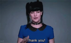 A Woman In A Blue Shirt And Choker Is Saying Thank You . GIF